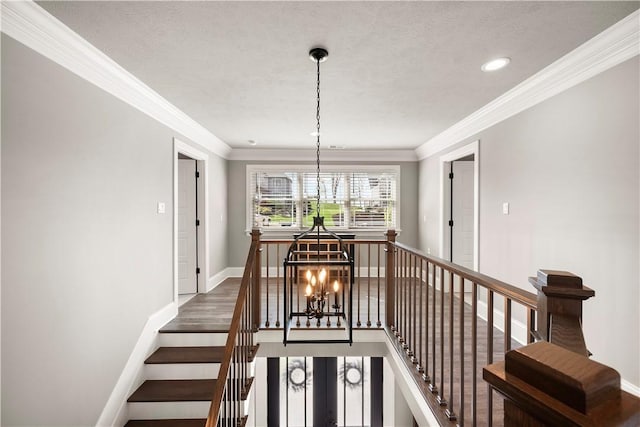 131 Woodford Dr, Adams Twp, PA 16033 - staircase with crown molding, wood finished floors, baseboards, recessed lighting, and a notable chandelier