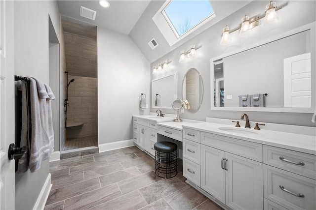 131 Woodford Dr, Adams Twp, PA 16033 - full bath with a skylight, visible vents, tiled shower, and vanity
