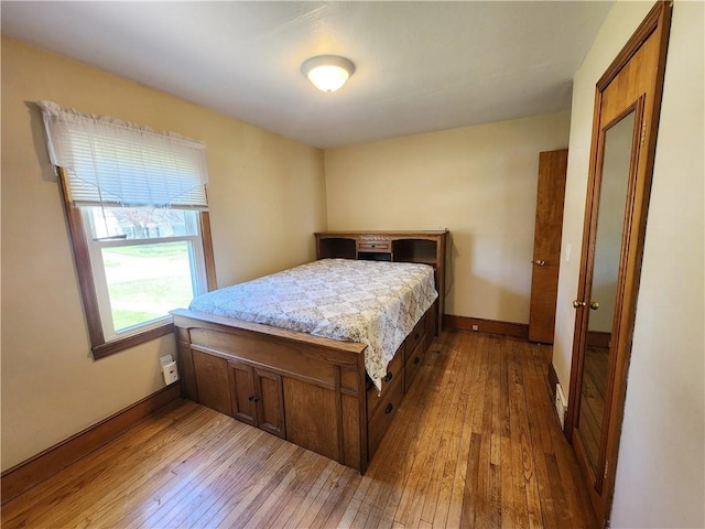 bedroom featuring baseboards and hardwood / wood-style flooring