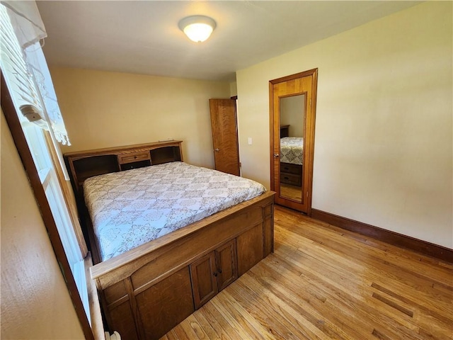 bedroom with baseboards and light wood-style floors