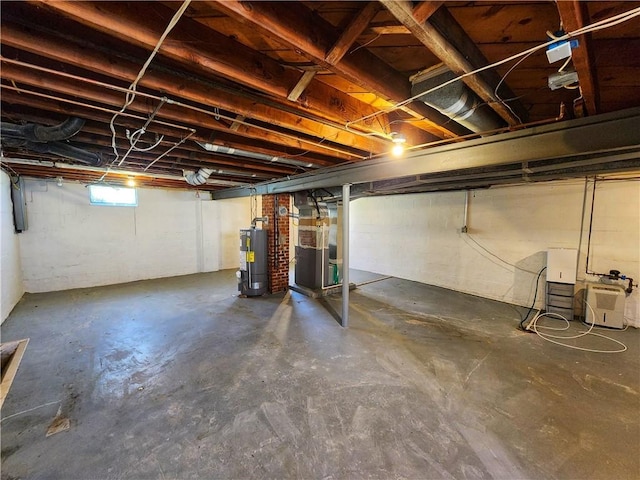 basement featuring heating unit and water heater