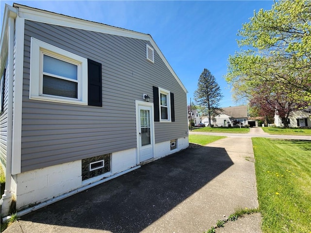 view of property exterior featuring a lawn