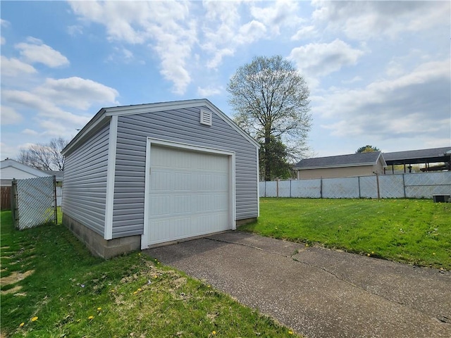 detached garage with fence and driveway