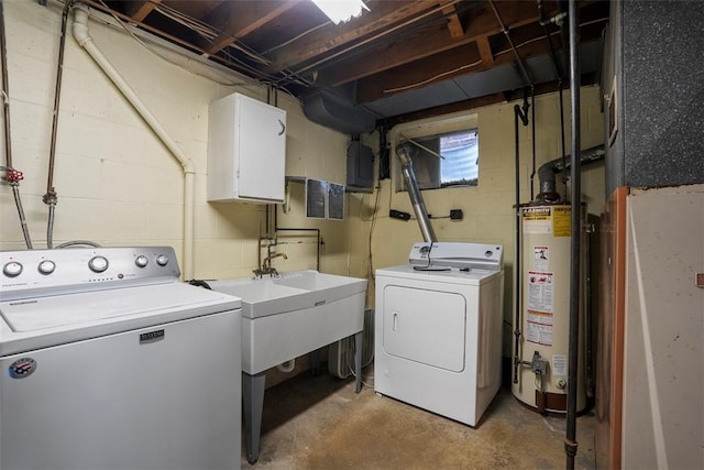 washroom featuring laundry area, gas water heater, concrete block wall, and washing machine and dryer