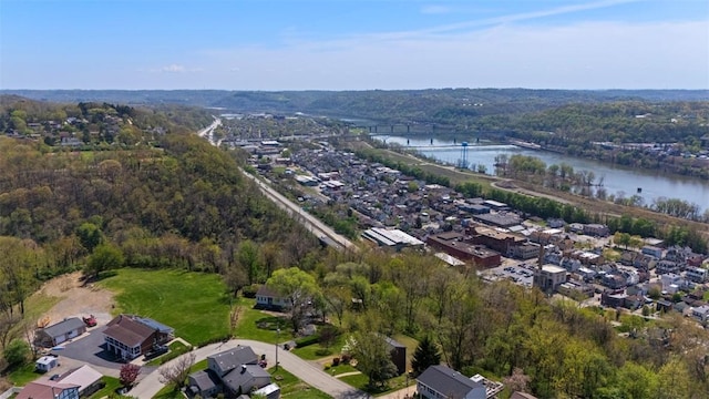 birds eye view of property featuring a water view, a view of trees, and a residential view
