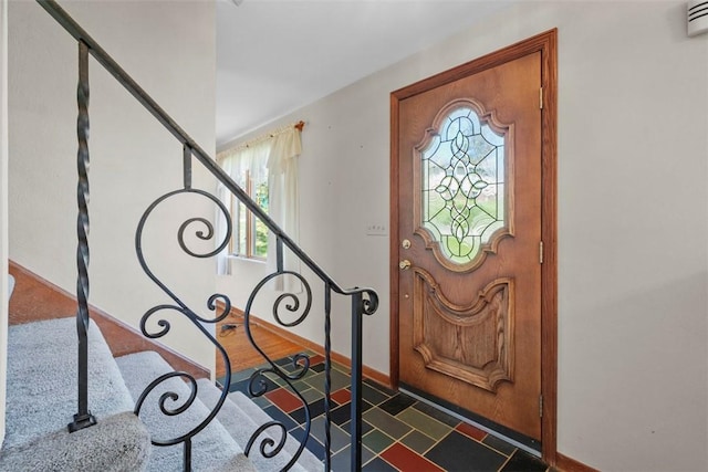 entrance foyer with baseboards and stairway
