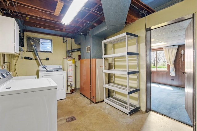 basement with water heater and washing machine and clothes dryer