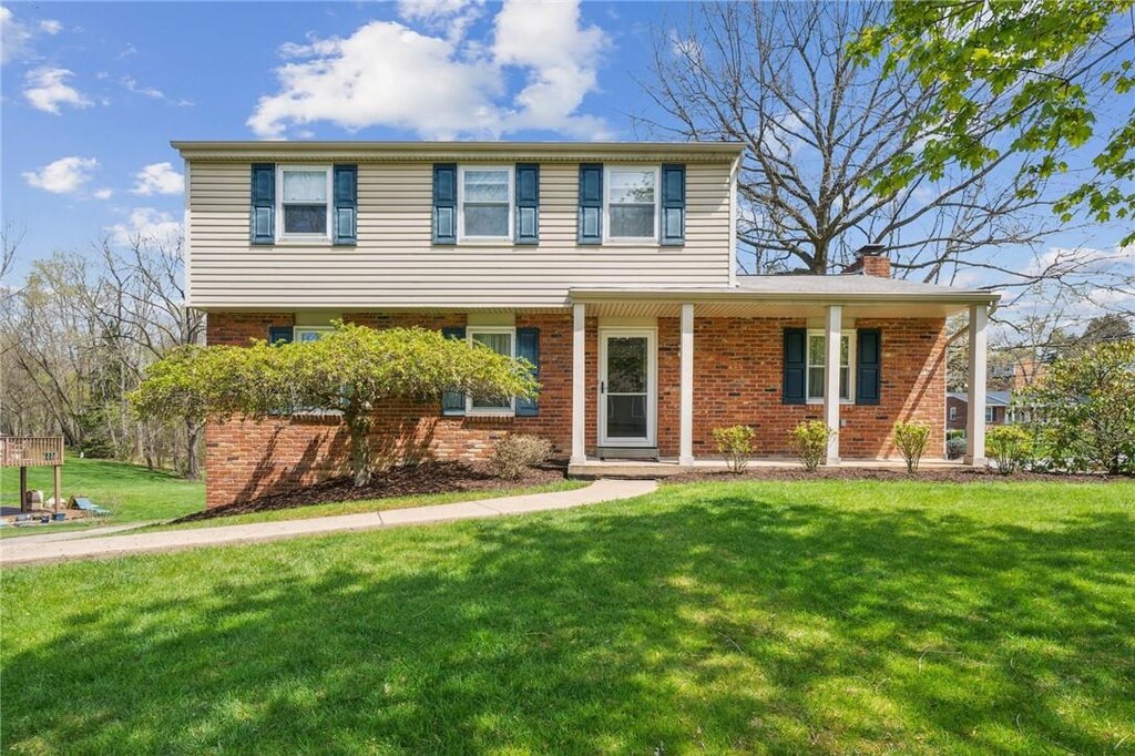200 Kinvara Dr, Ross Twp, PA 15237 - view of front facade with brick siding, a front lawn, and a chimney