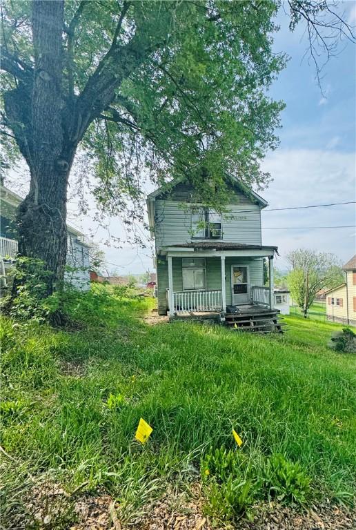 rear view of property featuring a porch