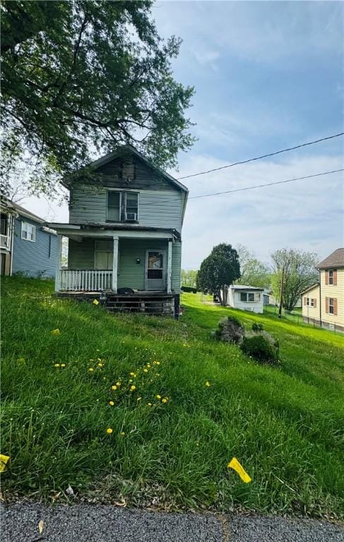 rear view of property featuring a porch
