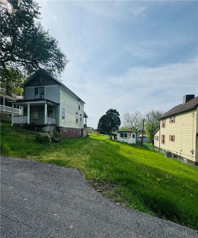 view of property exterior featuring a porch and central AC