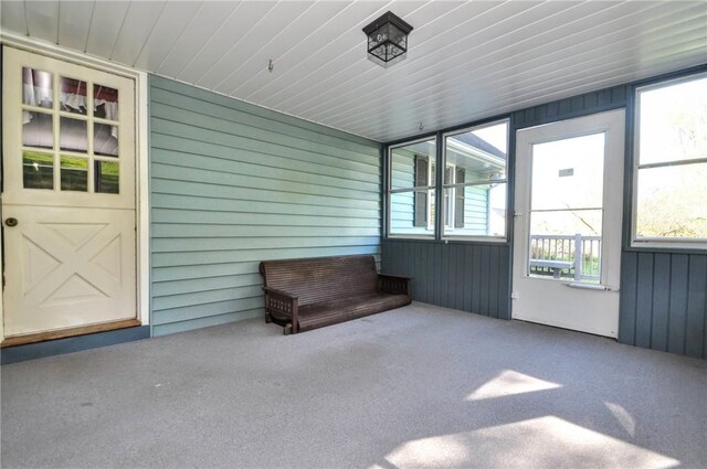 unfurnished sunroom featuring a wealth of natural light