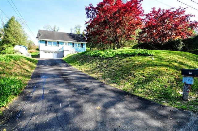 view of front facade with an attached garage, driveway, and a front yard