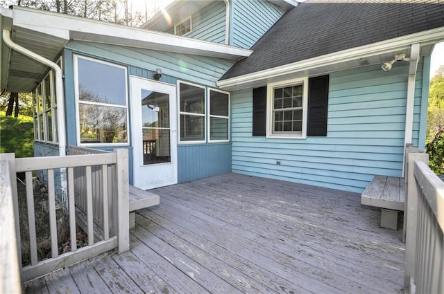 wooden deck featuring a sunroom