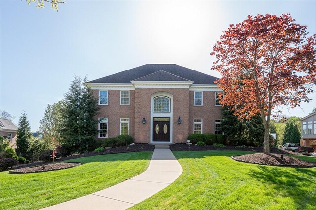 view of front of property with brick siding and a front yard