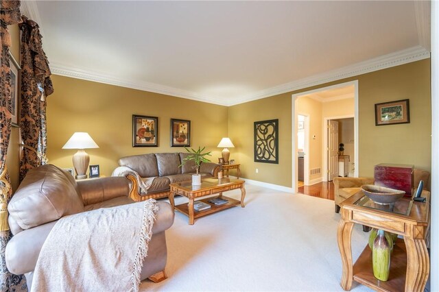 carpeted living room with baseboards and ornamental molding