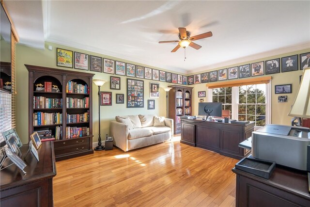 office with crown molding, light wood-style flooring, and ceiling fan