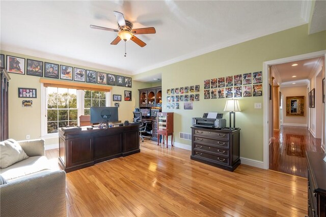 office with baseboards, a ceiling fan, light wood finished floors, and visible vents