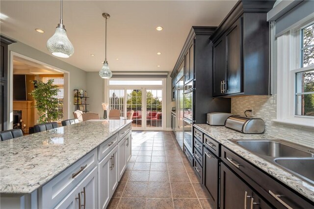kitchen featuring a center island, decorative backsplash, recessed lighting, and hanging light fixtures