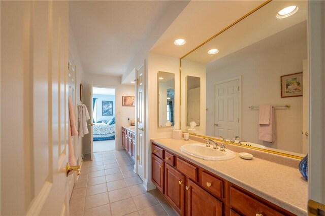 ensuite bathroom with tile patterned flooring, recessed lighting, connected bathroom, and vanity