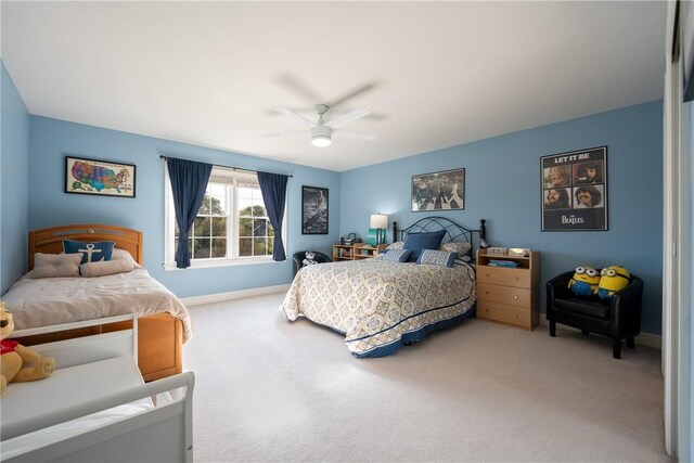 bedroom with carpet floors, a ceiling fan, and baseboards