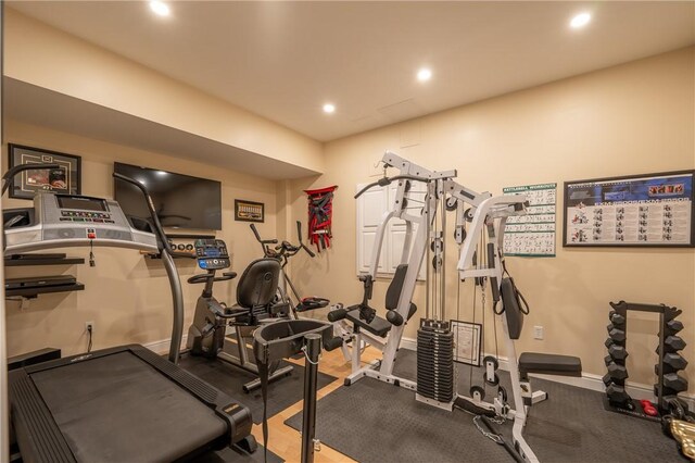 exercise room with baseboards and recessed lighting