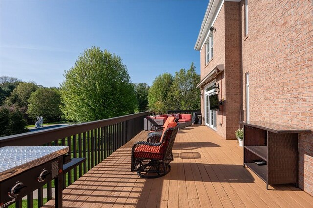 wooden terrace featuring an outdoor hangout area
