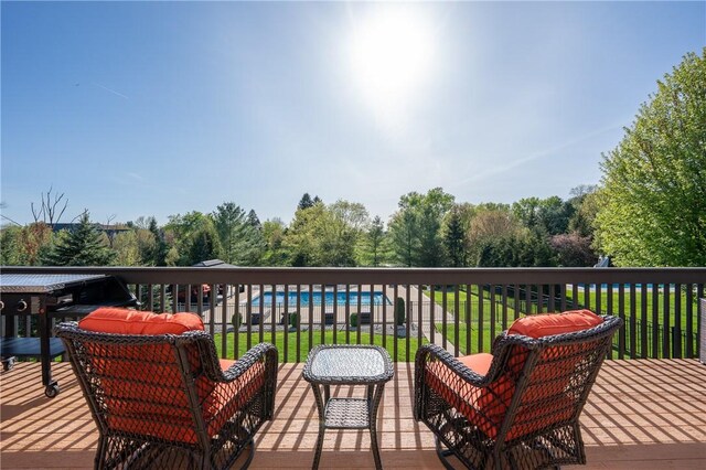 wooden deck featuring a lawn