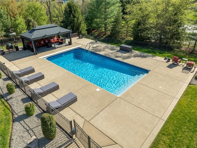 view of swimming pool with fence, a gazebo, a fenced in pool, and a patio area