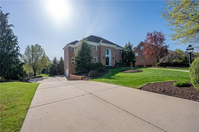 exterior space with a lawn and concrete driveway