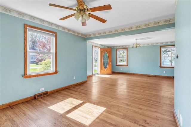 empty room with baseboards, light wood-style flooring, and visible vents