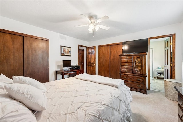 bedroom with ceiling fan, visible vents, and light carpet