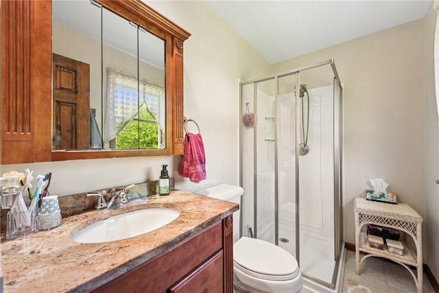 full bath featuring vanity, tile patterned floors, toilet, and a shower stall