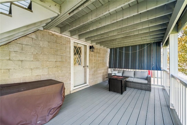 wooden terrace with an outdoor hangout area