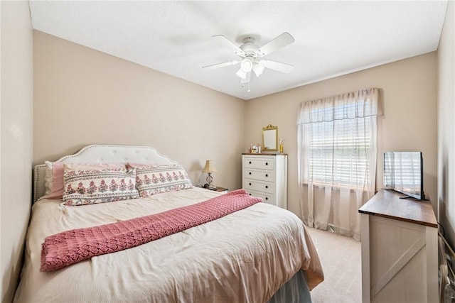 bedroom with ceiling fan and light carpet