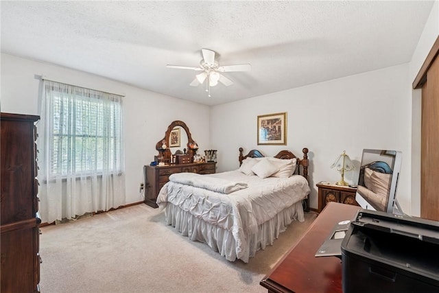 bedroom featuring light colored carpet and ceiling fan