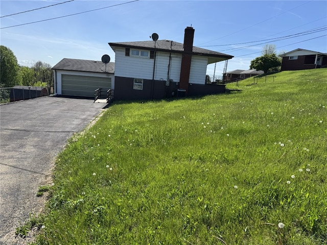 412 Helen Ave, Monessen, PA 15062 - view of home's exterior featuring a detached garage and a chimney