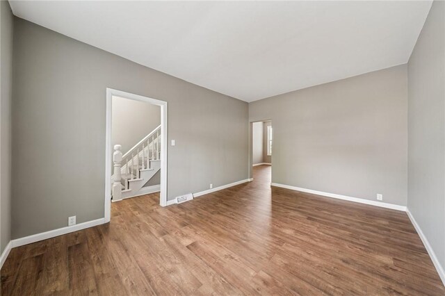 544 4th Ave, New Kensington, PA 15068 - empty room featuring baseboards, visible vents, wood finished floors, and stairway