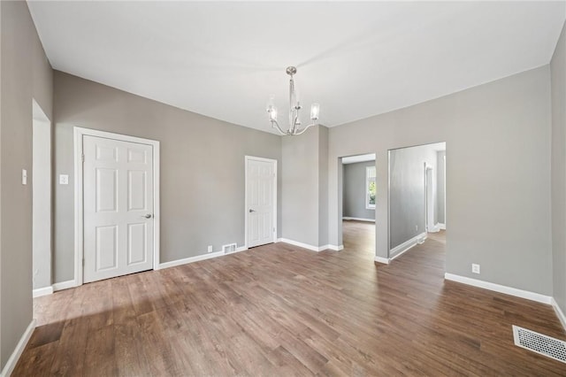 544 4th Ave, New Kensington, PA 15068 - unfurnished dining area featuring baseboards, an inviting chandelier, wood finished floors, and visible vents