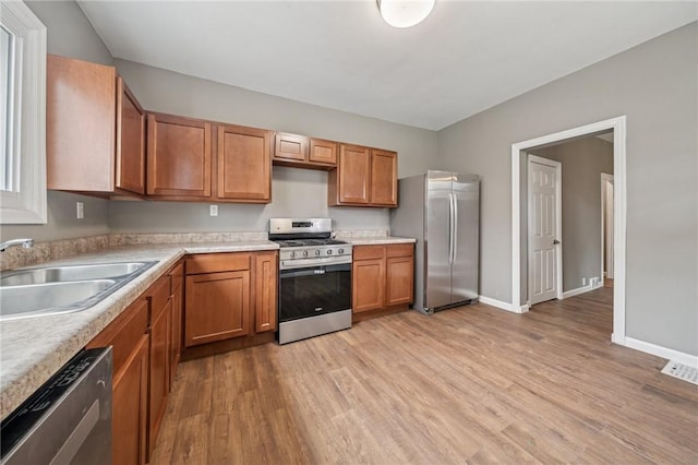 544 4th Ave, New Kensington, PA 15068 - kitchen with a sink, appliances with stainless steel finishes, light wood-style floors, and light countertops