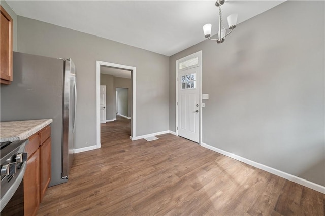 544 4th Ave, New Kensington, PA 15068 - interior space with brown cabinets, light countertops, a chandelier, stainless steel appliances, and baseboards