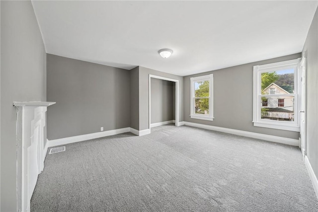 544 4th Ave, New Kensington, PA 15068 - unfurnished living room featuring visible vents, carpet flooring, and baseboards