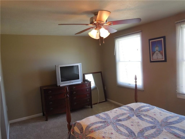 bedroom with baseboards, carpet flooring, and a ceiling fan