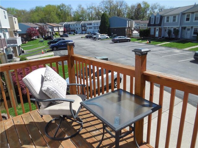 wooden terrace with covered porch and a residential view