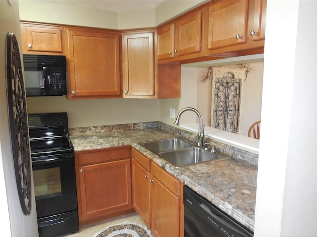 kitchen featuring brown cabinets, a sink, light countertops, light tile patterned floors, and black appliances