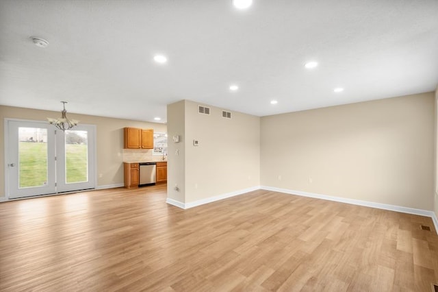 1809 Coursin St, Mckeesport, PA 15132 - unfurnished living room with recessed lighting, a chandelier, and light wood finished floors