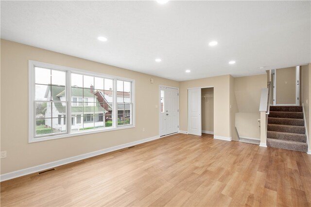 1809 Coursin St, Mckeesport, PA 15132 - unfurnished living room featuring visible vents, recessed lighting, baseboards, stairs, and light wood-style flooring