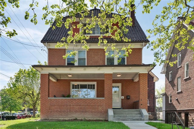 view of front of home featuring a porch and brick siding