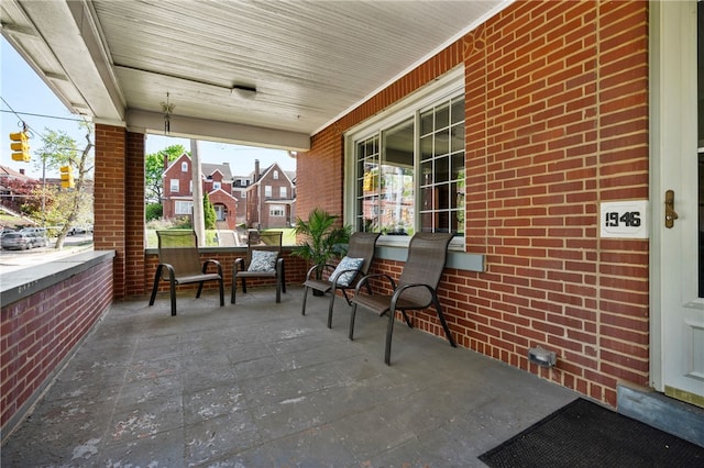 view of patio / terrace featuring covered porch and a residential view