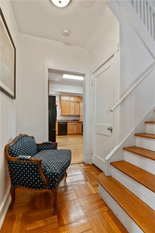 foyer entrance featuring stairway and baseboards